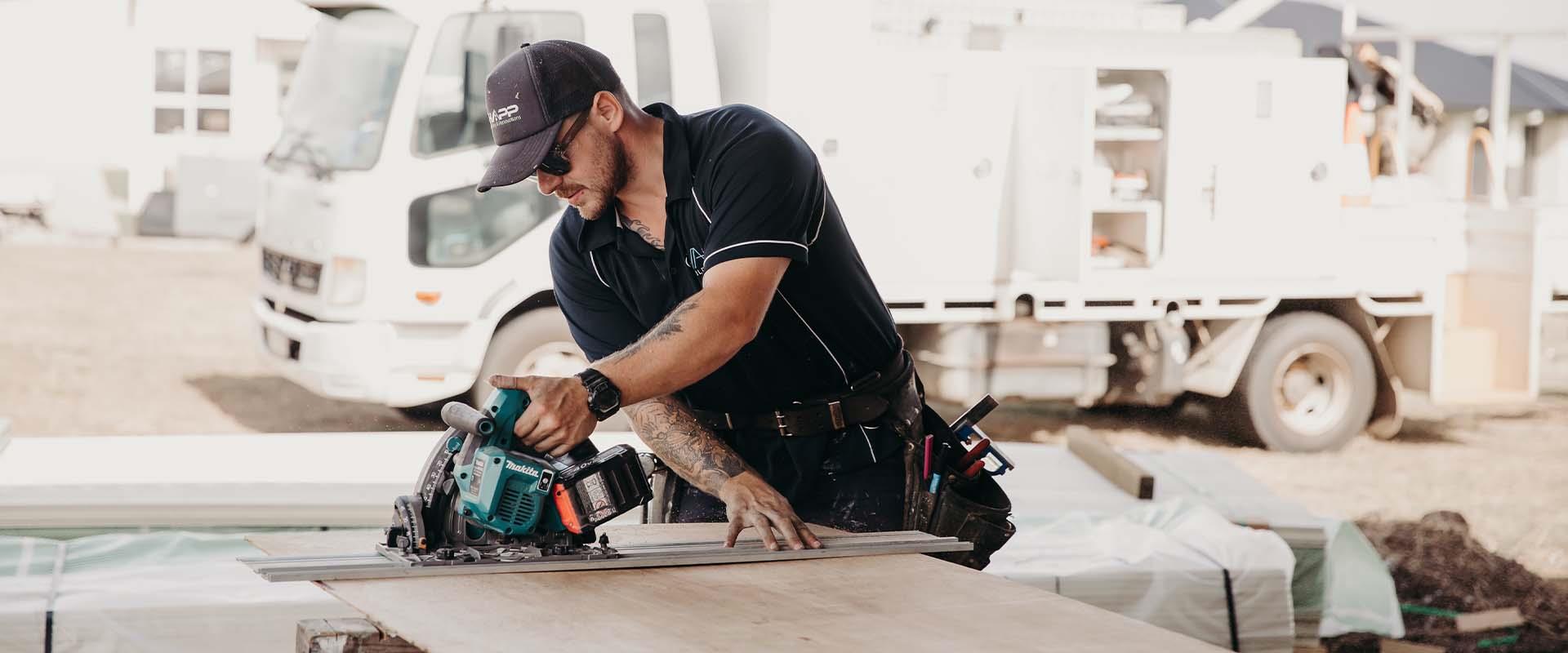 builder cutting building materials with power tools