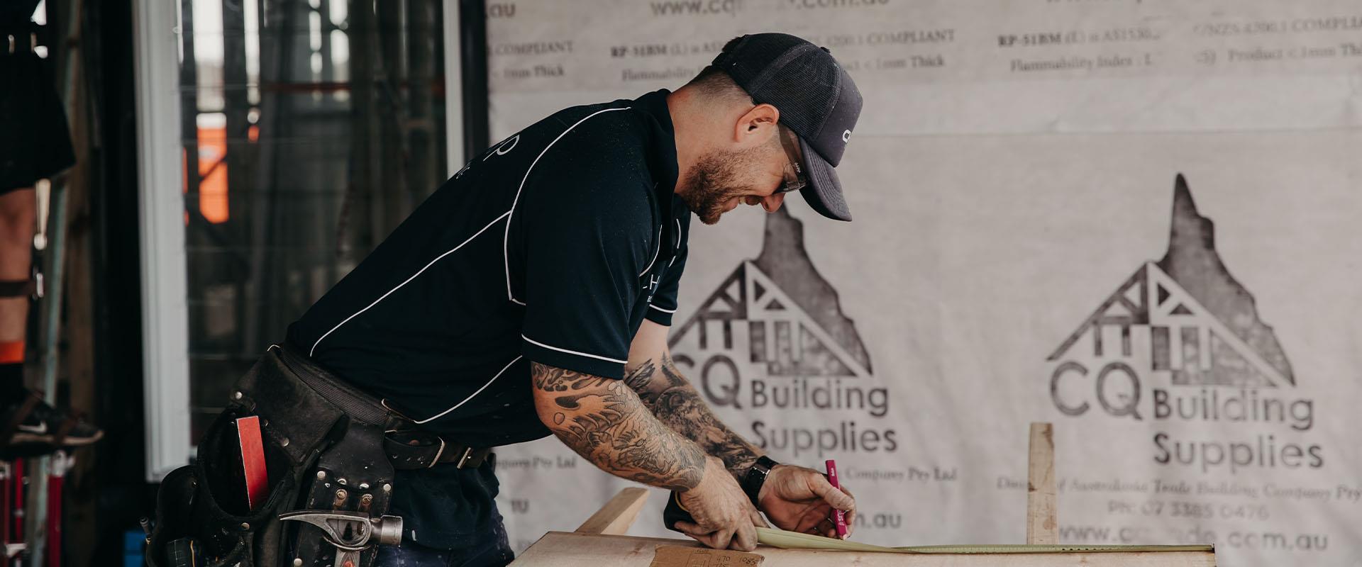 builder smiling and making measurements